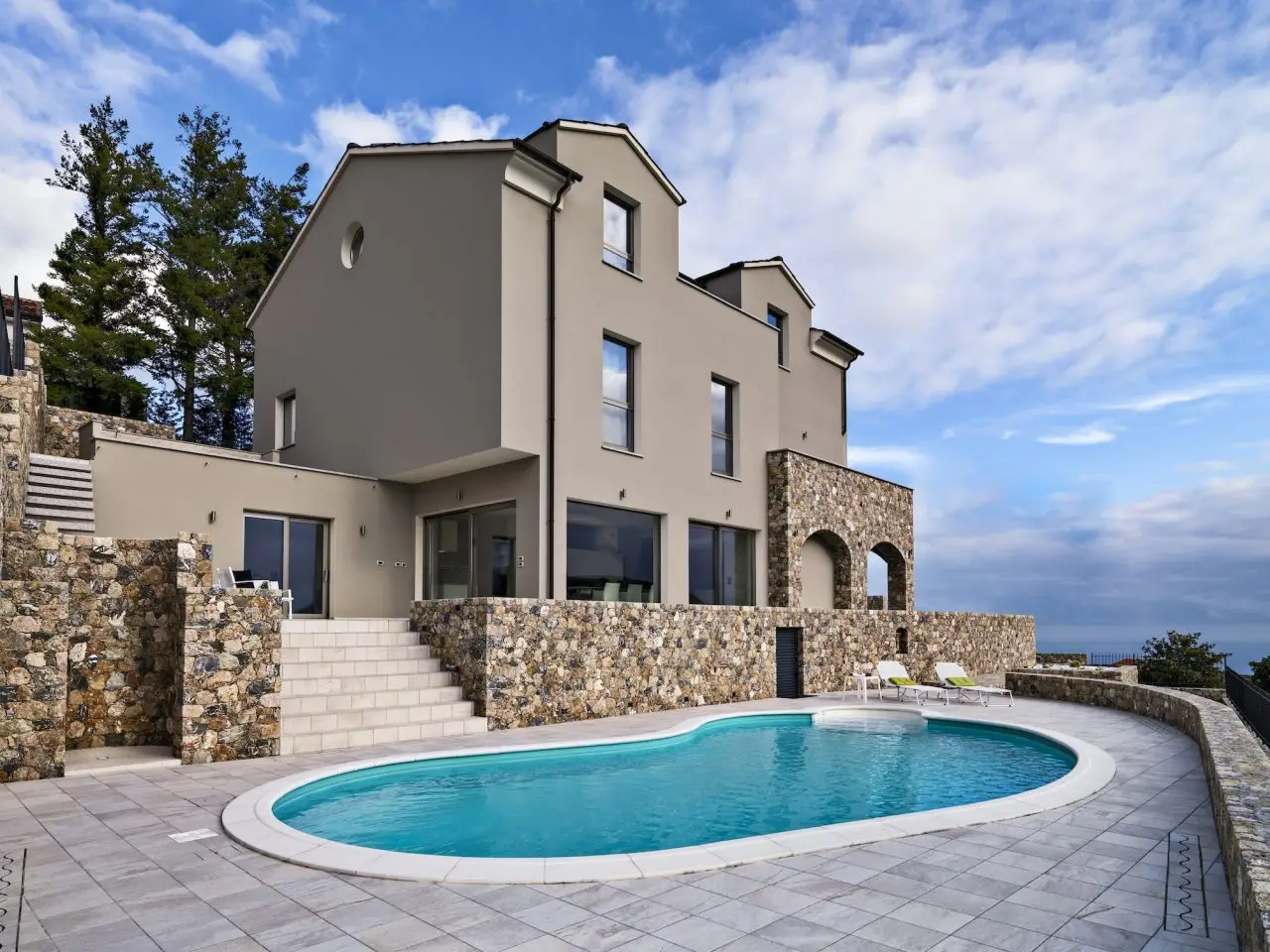 exteriors view of a modern villa in the foreground the swimming pool